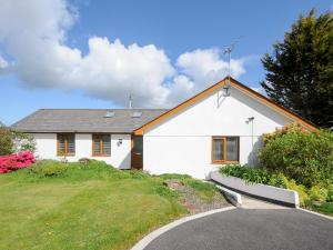 a white house with a driveway in front of it at Lambley View in Bude