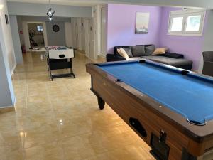 a living room with a pool table in it at Family Rooms in Stavros
