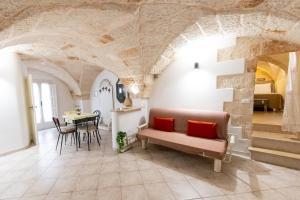 a living room with a couch and a table at La Stella Del Pupo CATALDO in Fasano