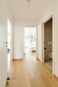 a white room with white walls and a wooden floor at Luxurious 2BR Family Apartment - Champel in Geneva