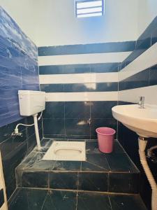 a bathroom with a sink and a toilet at The HIGHLIGHT STAY in Uttarkāshi +126 photos