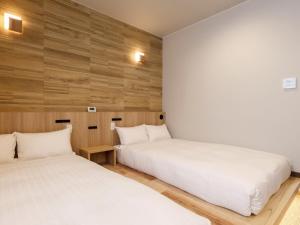 Rúm í herbergi á Hotel Kii Tanabe