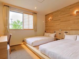 Rúm í herbergi á Hotel Kii Tanabe