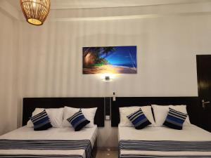 Postel nebo postele na pokoji v ubytování Sun sea guest home