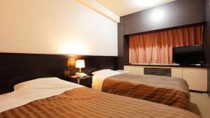 Postel nebo postele na pokoji v ubytování Atami New Fujiya Hotel