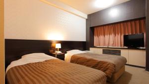 Postel nebo postele na pokoji v ubytování Atami New Fujiya Hotel