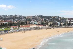 a view of a beach with a city in the background at Iconic Bondi Beach Views in Sydney