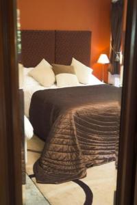 
a bedroom with a bed and a dresser at Scafell Hotel in Rosthwaite
