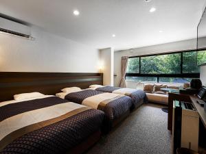 Postel nebo postele na pokoji v ubytování Izutsu hotel Takasegawa
