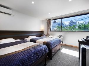 Postel nebo postele na pokoji v ubytování Izutsu hotel Takasegawa