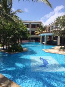 a swimming pool with a dolphin painted on it at Baobab Holiday Resort in Bamburi