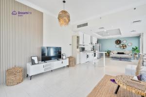 Televizorius ir (arba) pramogų centras apgyvendinimo įstaigoje Spacious 1BR Apartment Lake View Tower, Cluster B JLT