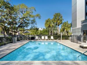 a swimming pool in a building with a building at Hyatt Place Tampa Busch Gardens in Tampa