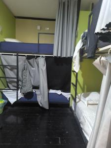 a room with two bunk beds with clothes at 我的房间 in Vientiane