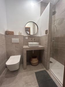 a bathroom with a toilet and a sink and a mirror at Estudio 1 Café Bernal in Tarifa +13 photos