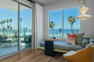 a living room with a couch and a view of the ocean at Mission Pacific Beach Resort, part of JdV by Hyatt in Oceanside