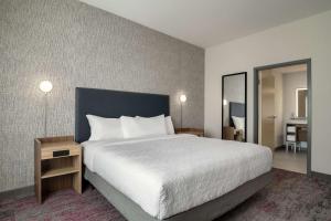 a hotel room with a large bed and a mirror at Home2 Suites By Hilton Conyers Atlanta in Conyers +40 photos