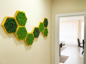 a wall with a green recycle sign on a wall at Elite Business Residence with Free Gym Pass, Street Parking and Full Office Setup in Plovdiv