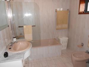 a bathroom with a tub and a sink and a toilet at Vila do Conde Holidays Flat in Areia