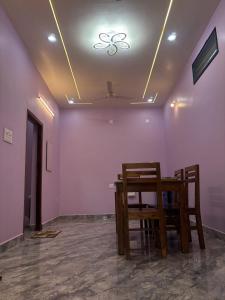a dining room with a table and two chairs at Delight villa in Kottakupam