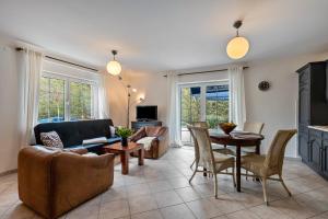 a living room with a couch and a table at Ferienwohnung Am Wasser in Groß Lindow