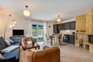 a living room with a couch and a table at Ferienwohnung Am Wasser in Groß Lindow