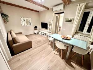 a living room with a table and a couch at La Terrazza dei Santi in Lucca