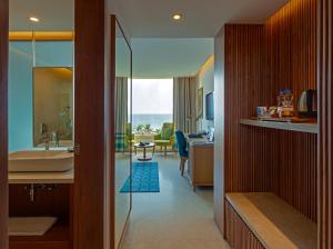 a bathroom with a tub and a sink and a desk at The Park Visakhapatnam in Visakhapatnam