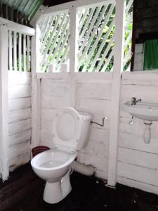 a bathroom with a toilet and a sink at Masoala bungalows in Maroantsetra