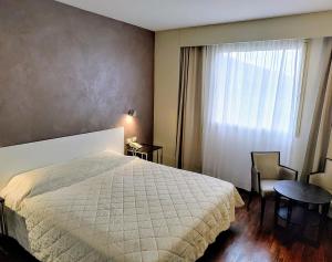 Letto o letti in una camera di Hotel Datini