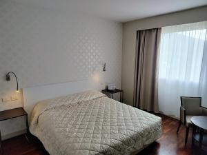 Letto o letti in una camera di Hotel Datini