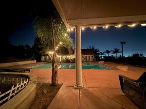 a swimming pool at night with lights on a patio at Riverside Views & Pool Retreat in Riverside