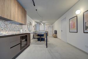 a kitchen with a counter and a table in it at Juliet Residence, Apt 4 , Your Home Away from Home in Gzira by SF HOMES in Il-Gżira