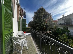a patio with two chairs and a table on a balcony at Villa Rocca - appartamento 3 in Borgio Verezzi