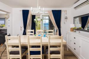 a dining room with a table and chairs at Apartment GL in Stanići