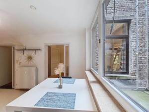 a white table in a room with a large window at Amazing Studio Charleroi Central Station in Charleroi