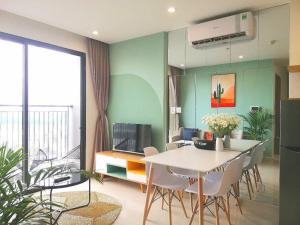 a living room with a table and chairs and a tv at LK Homestay S218 in Gia Lâm Pho