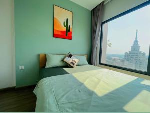 a bedroom with a bed with a large window at LK Homestay S218 in Gia Lâm Pho
