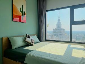 a bedroom with a bed with a large window at LK Homestay S218 in Gia Lâm Pho