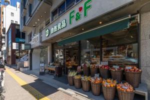 a grocery store with baskets of fruit in front of it at REJ Reflet Ebisu in Tokyo