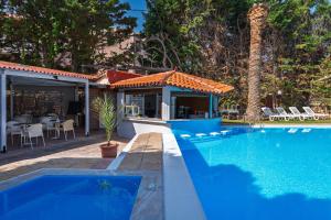 a swimming pool next to a house at Pantheon Hotel in Rethymno