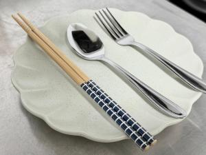 a plate with two forks and a spoon on it at 桜南大塚ハウスii in Tokyo +18 photos