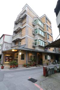 a tall building on a city street with at Mozhu B&B in Hualien City