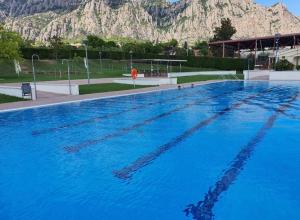 a large swimming pool with a mountain in the background at Casa Annie in Collbató