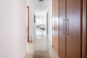a hallway with wooden cabinets and a rug at Frank Porter - Saba 3 in Dubai