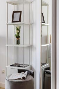 a chair in a room with white shelves at Frank Porter - Saba 3 in Dubai