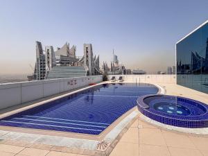 a swimming pool on top of a building with buildings at Frank Porter - Saba 3 in Dubai