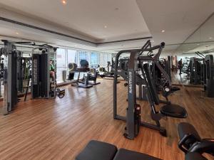 a gym with several treadmills and machines in a room at Frank Porter - Saba 3 in Dubai
