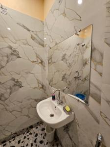 a bathroom with a sink and a mirror at Krishna's land in Vrindāvan