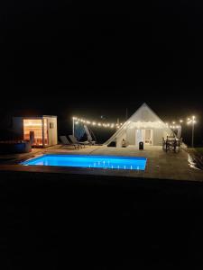 a house with a swimming pool at night at Naše Búda in Vlkoš